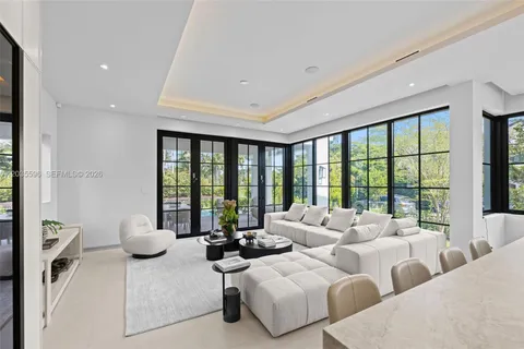 a spacious bedroom with a large bed and a large window