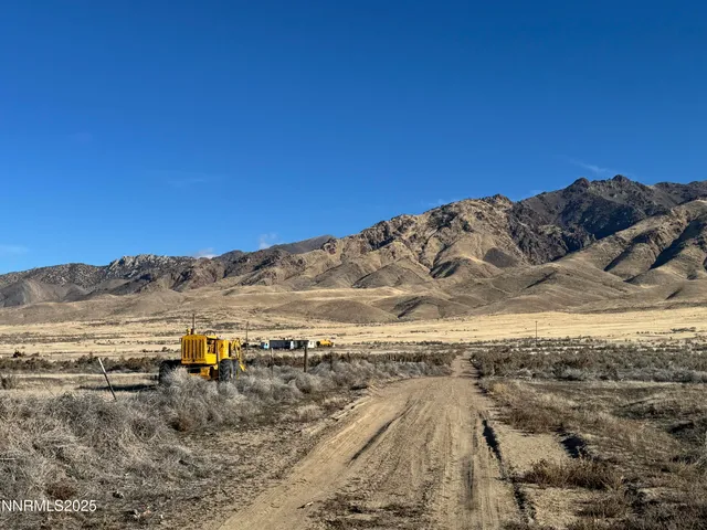 a view of a large mountain with mountains in the background