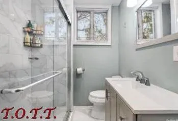 a bathroom with a sink and mirror with toilet