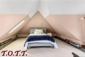 a bedroom with a bed and a night stand