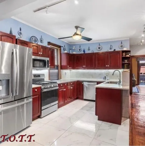 a kitchen with stainless steel appliances granite countertop a stove oven and a refrigerator