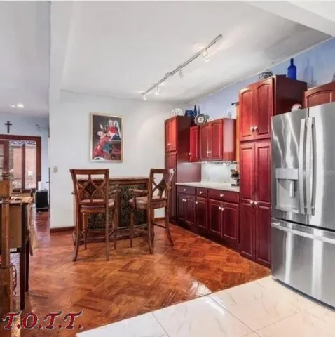 a dining area with stainless steel appliances kitchen island granite countertop furniture and a kitchen view