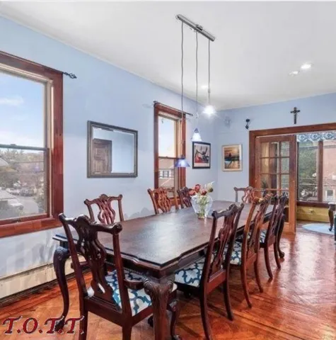 a view of a dining room with furniture window and wooden floor