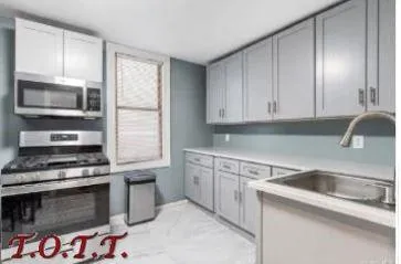a kitchen with granite countertop a sink and a stove top oven