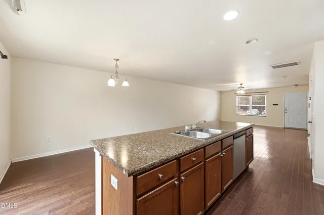 a kitchen with granite countertop cabinets a sink and dishwasher