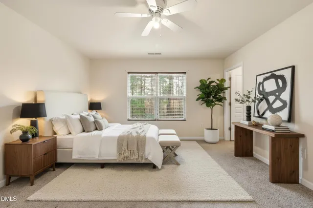 a bedroom with a large bed and a window