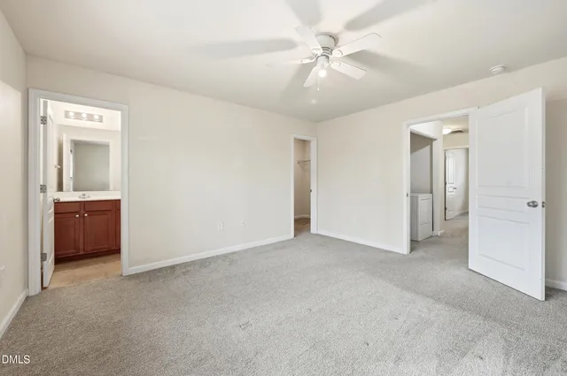 an empty room with a bathroom and a sink