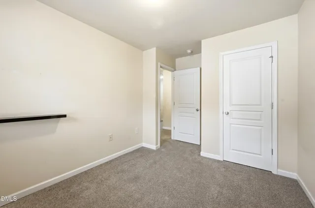 an empty room with closet area