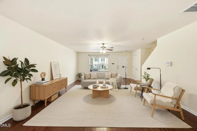 a living room with furniture and a chandelier