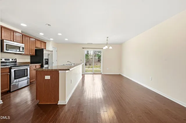 a large kitchen with stainless steel appliances sink a microwave and stove