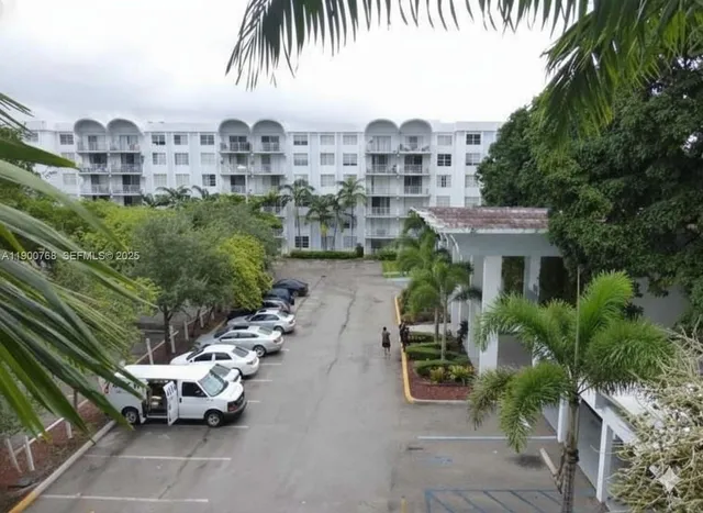 a view of a balcony with a floor to ceiling window and potted plants