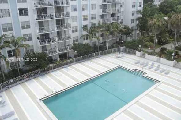 494 Northwest 165th Street, Unit C602 Miami, FL 33169 - Photo 2 of 12 a view of a balcony with a floor to ceiling window and potted plants