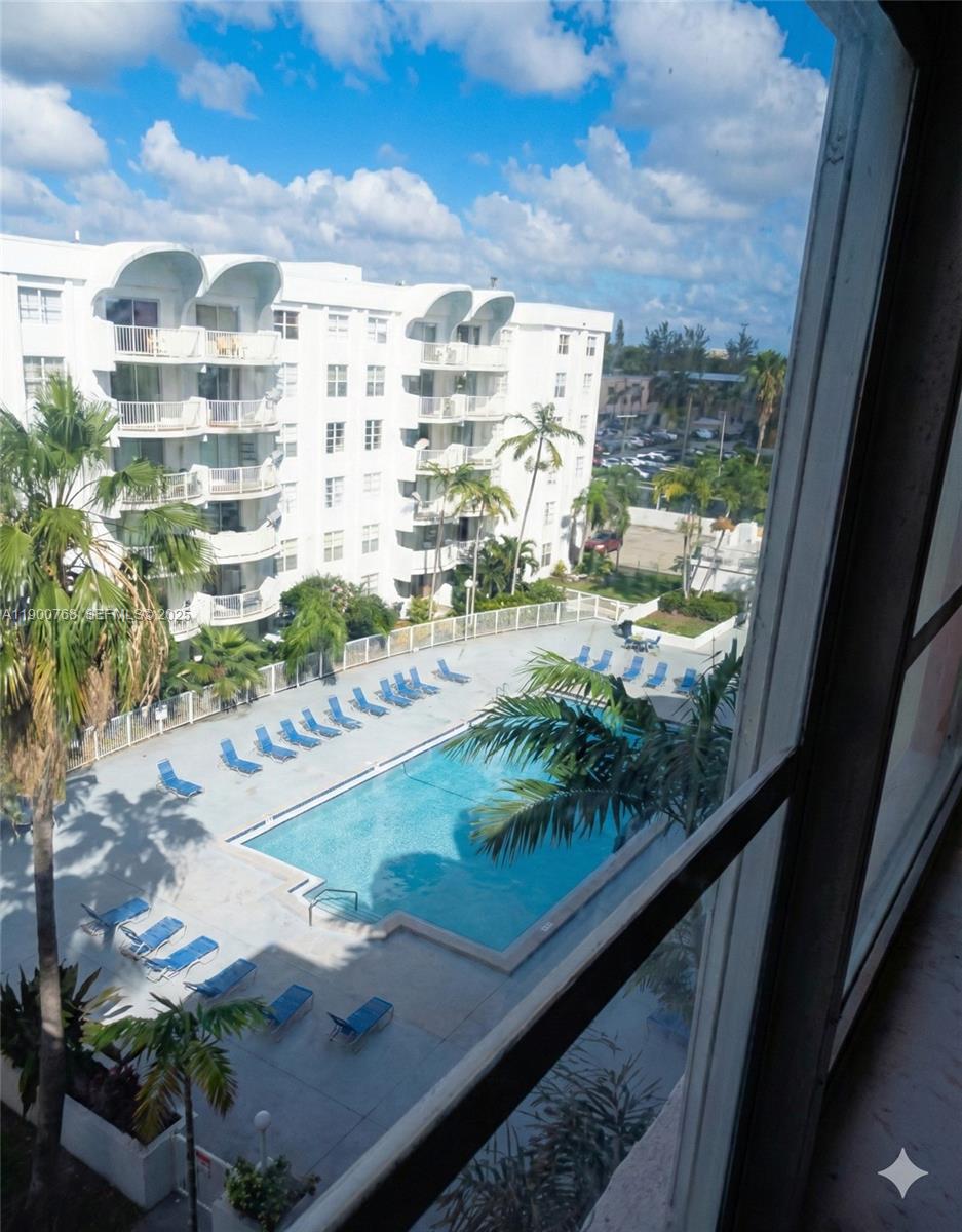 494 Northwest 165th Street, Unit C602 Miami, FL 33169 - Photo 3 of 12 a view of swimming pool from a window