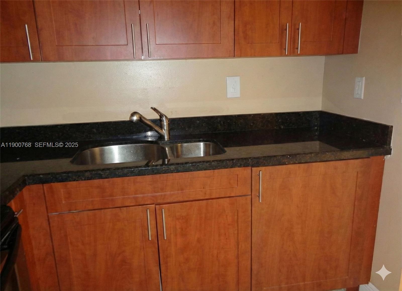 494 Northwest 165th Street, Unit C602 Miami, FL 33169 - Photo 8 of 12 a close view of sink and cabinets