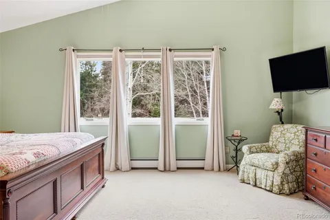 a bed room with a bed and a television