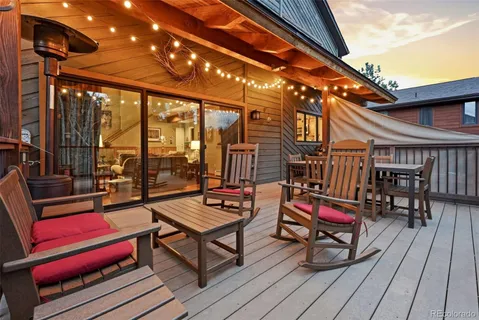 a sitting area with furniture and wooden deck