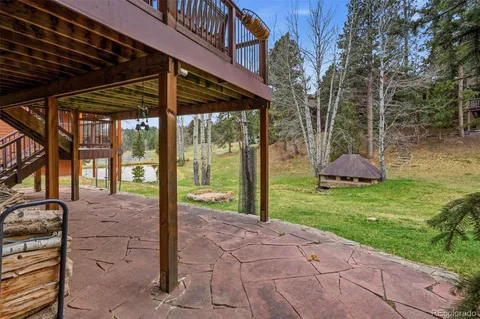 a backyard of a house with a fountain table and chairs