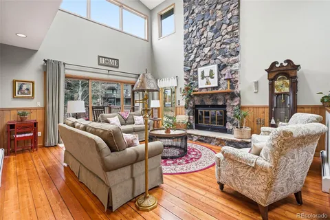 a living room with fireplace furniture and a fireplace