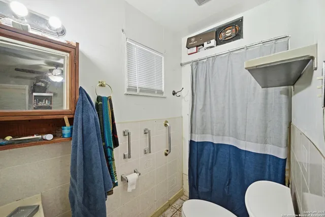 a bathroom with a toilet a sink and a mirror