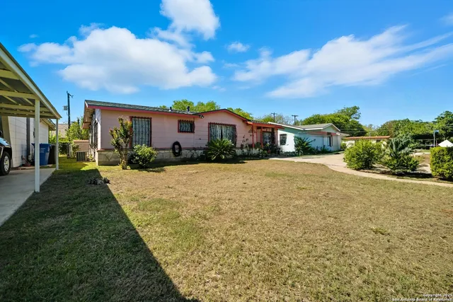 a view of house with yard and green space