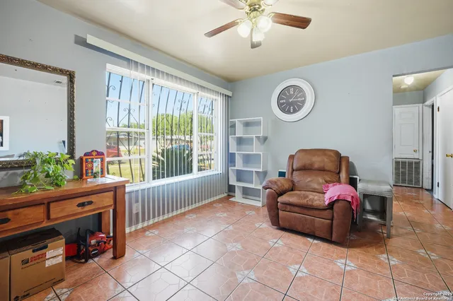a living room with furniture a couch and a window