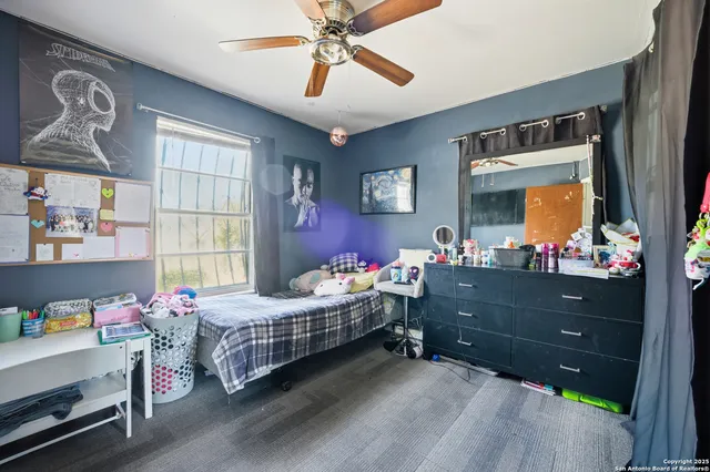 a bedroom with two beds and windows