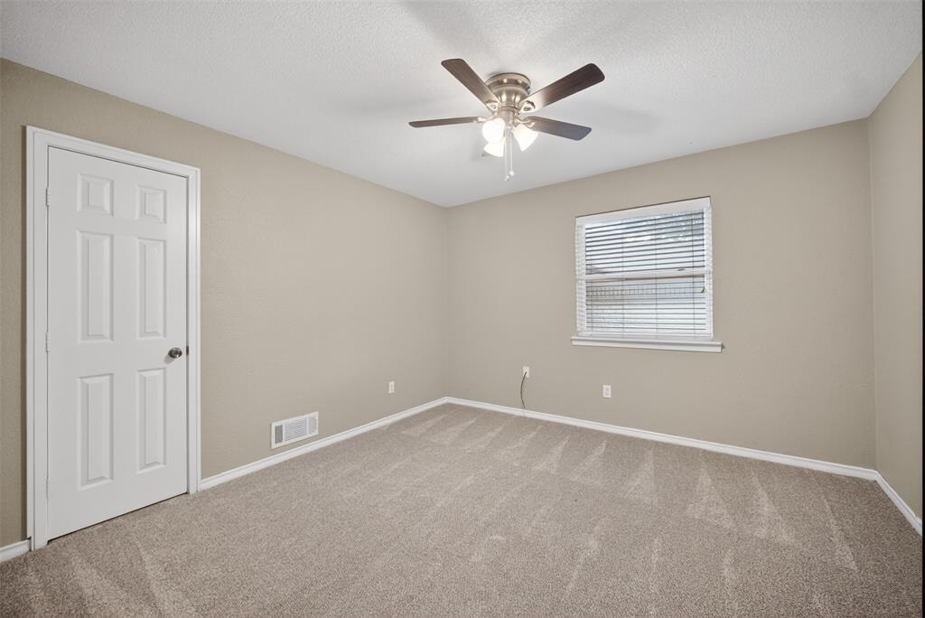 9660 Timberleaf Drive Dallas, TX 75243 - Photo 36 of 40 Carpeted room featuring a ceiling fan with light fixture, a window with blinds, and neutral painted walls