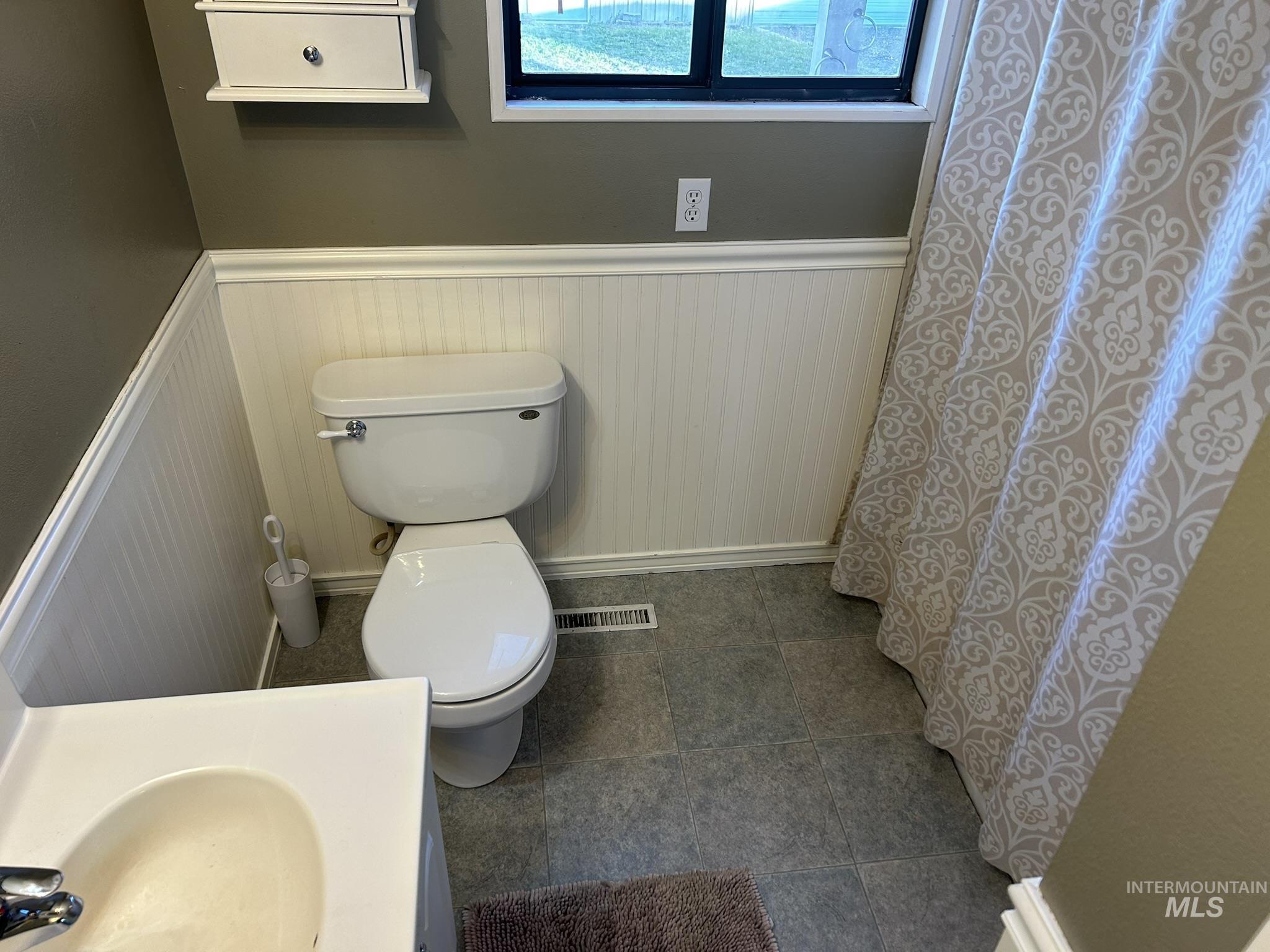 3731 16th Street Lewiston, ID 83501 - Photo 12 of 35 Bathroom with a wainscoted wall, a shower with curtain, and vanity