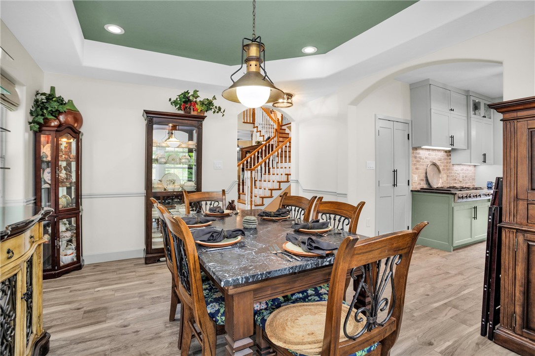 30820 Collier Smith Road Magnolia, TX 77354 - Photo 12 of 50 a dining room with furniture and wooden floor