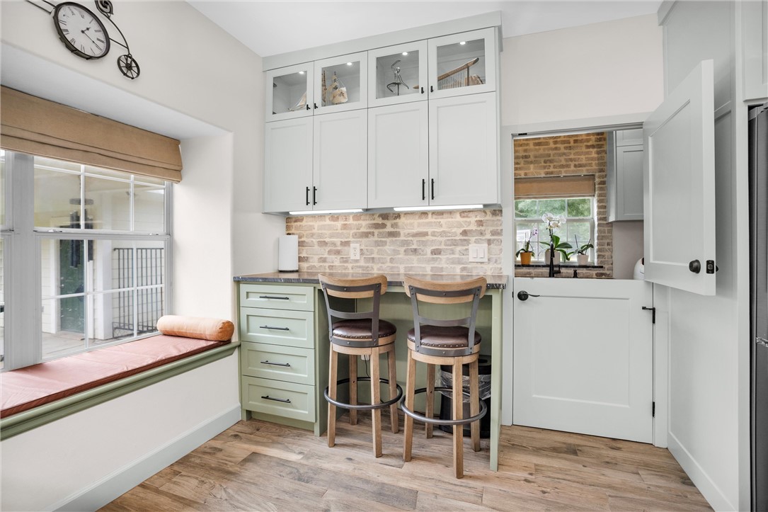 30820 Collier Smith Road Magnolia, TX 77354 - Photo 16 of 50 a kitchen with stainless steel appliances kitchen island granite countertop a table and chairs in it
