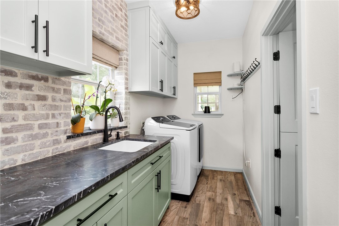 30820 Collier Smith Road Magnolia, TX 77354 - Photo 18 of 50 a kitchen with a sink a stove cabinets and a window