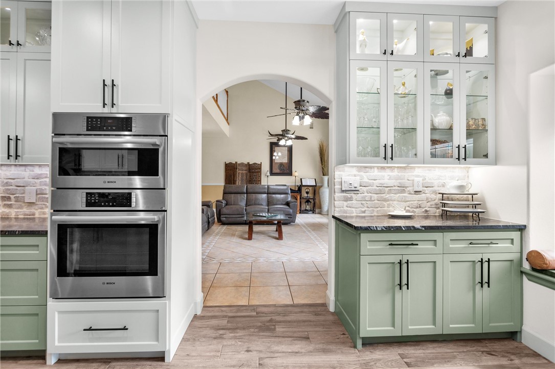 30820 Collier Smith Road Magnolia, TX 77354 - Photo 19 of 50 a kitchen with stainless steel appliances kitchen island granite countertop a stove and cabinets