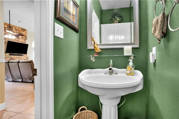 a living room with furniture a piano and a flat screen tv