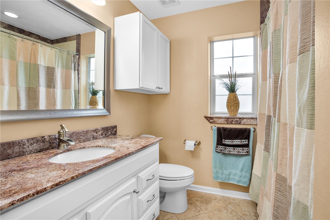 30820 Collier Smith Road Magnolia, TX 77354 - Photo 26 of 50 a bathroom with a granite countertop sink a toilet and a window