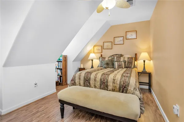 a bedroom with a bed and a mirror