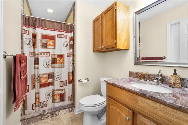 a bedroom with a bed and a painting on the wall