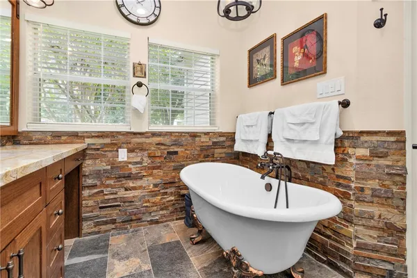 a view of walk in closet with clothes