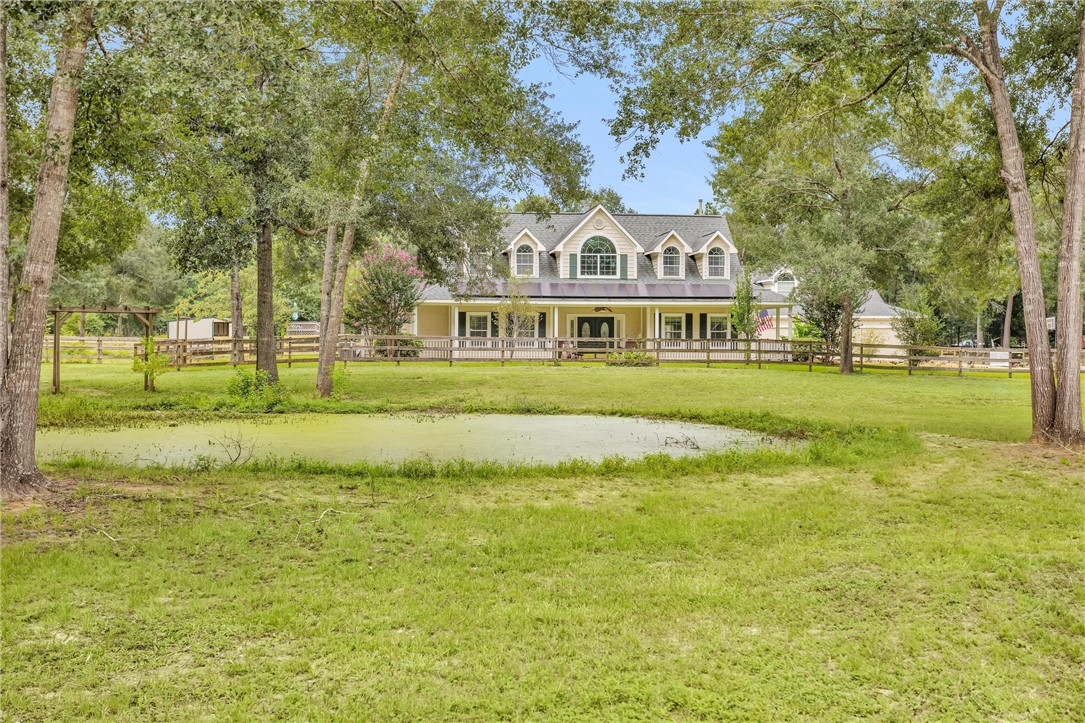 30820 Collier Smith Road Magnolia, TX 77354 - Photo 4 of 50 a view of swimming pool with a garden and trees