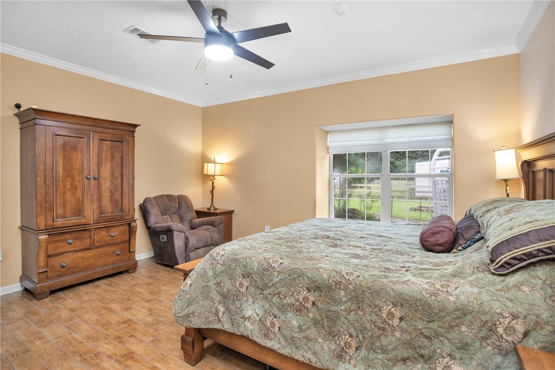 30820 Collier Smith Road Magnolia, TX 77354 - Photo 41 of 50 a bedroom with a bed and large windows