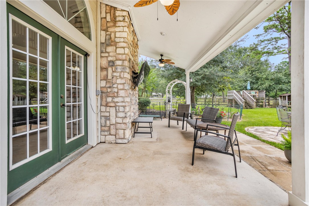 30820 Collier Smith Road Magnolia, TX 77354 - Photo 43 of 50 a view of a chairs and table in backyard of the house