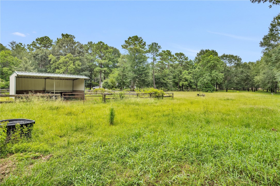 30820 Collier Smith Road Magnolia, TX 77354 - Photo 50 of 50 a view of a swimming pool with an outdoor space and seating area