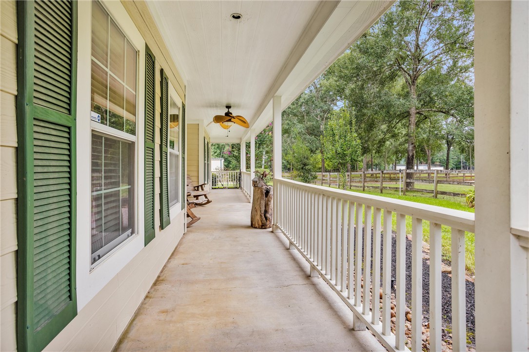 30820 Collier Smith Road Magnolia, TX 77354 - Photo 8 of 50 a view of a balcony with wooden floor and fence