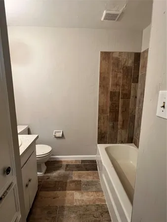a bathroom with a bathtub and toilet
