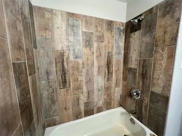a bathroom with a shower and a sink
