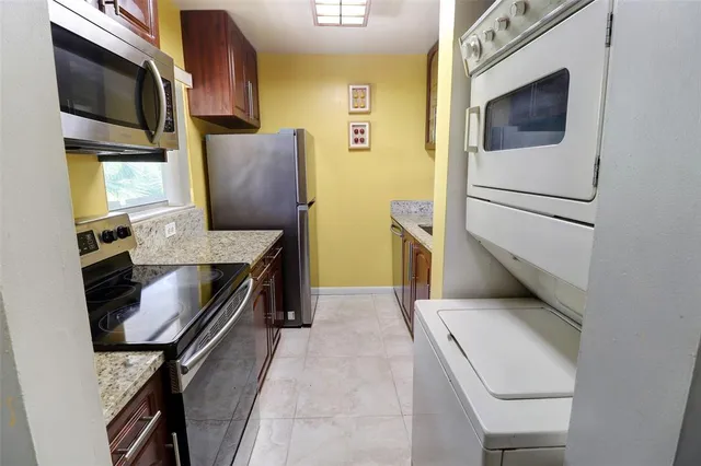 a kitchen with stainless steel appliances granite countertop a stove and a microwave