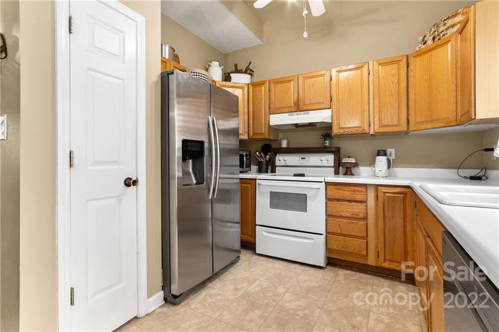 3505 Crow Burk Road Pageland, SC 29728 - Photo 17 of 30 a kitchen with white cabinets and white appliances