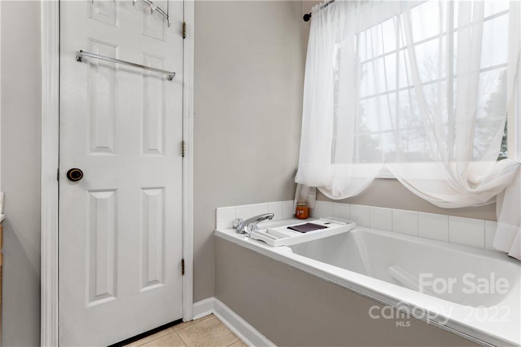 3505 Crow Burk Road Pageland, SC 29728 - Photo 28 of 30 a bathroom with a bathtub and a window