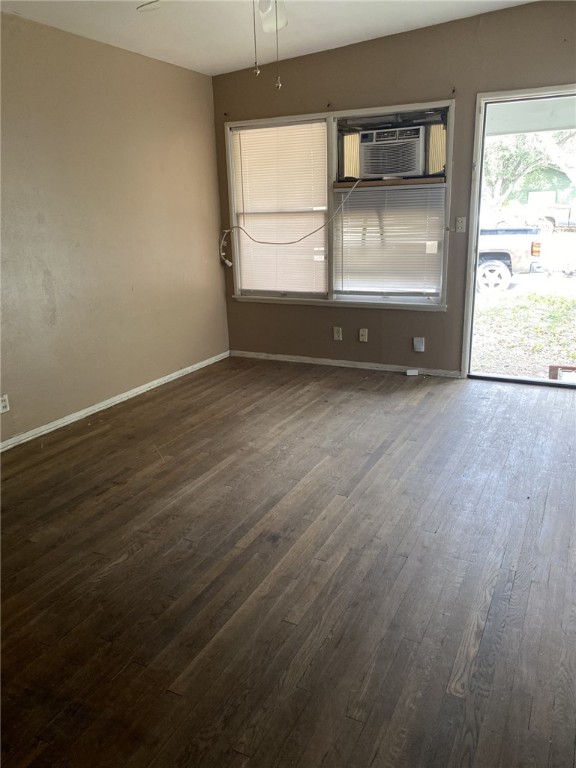 1100 South Cameron Street Alice, TX 78332 - Photo 3 of 18 an empty room with wooden floor and windows