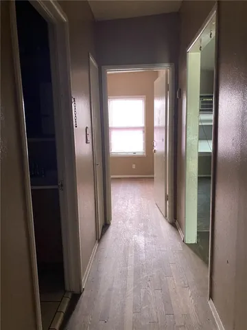 a view of hallway with a wooden floor