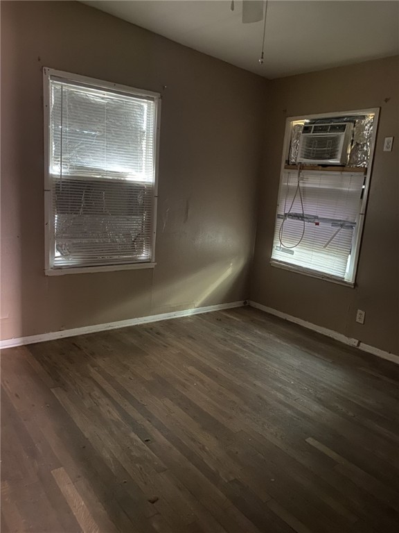 1100 South Cameron Street Alice, TX 78332 - Photo 9 of 18 an empty room with wooden floor and windows